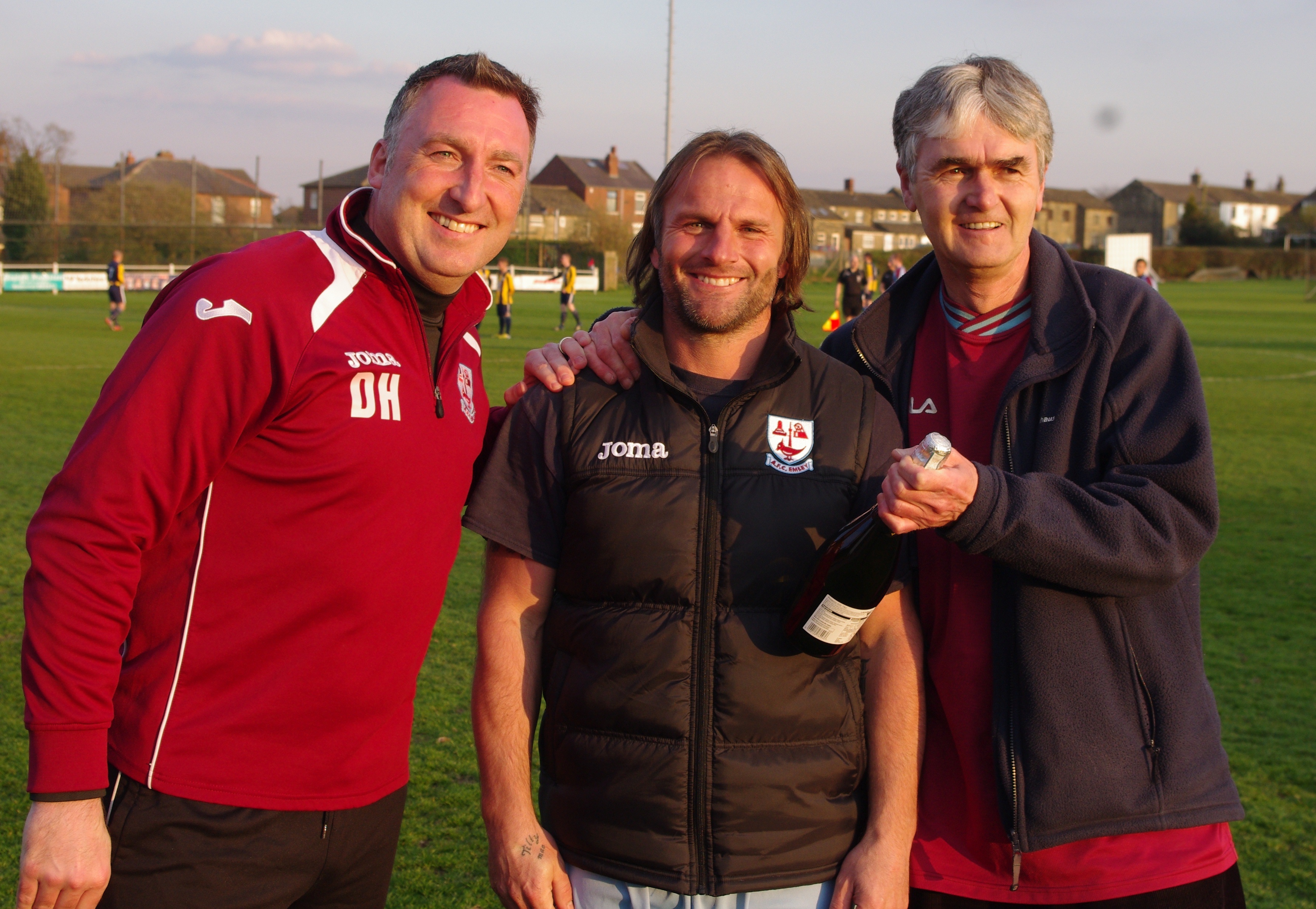 Mark Wilson (centre) celebrates his 900th game in semi-professional football