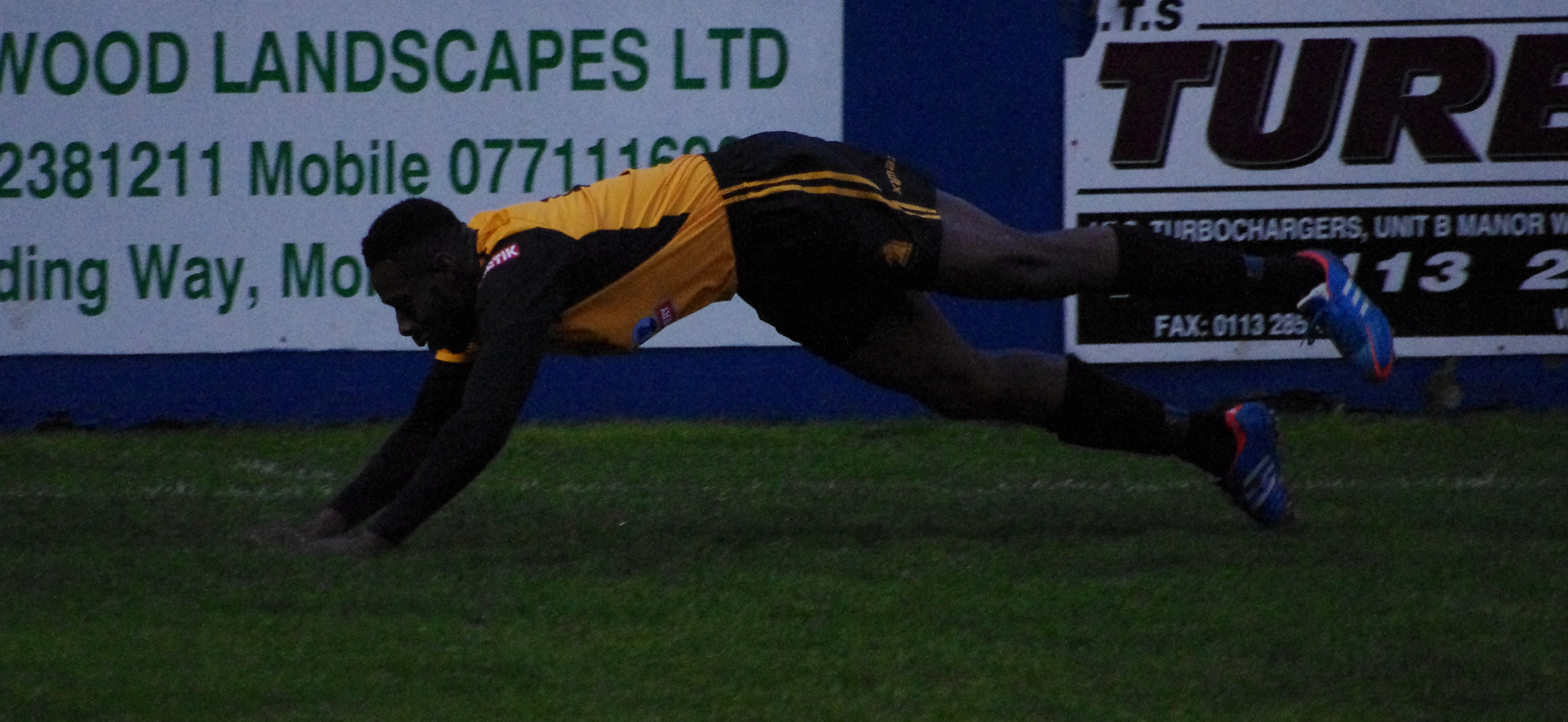 Tyrone Gay dives to the ground to celebrate opening the scoring for Ossett at Farsley