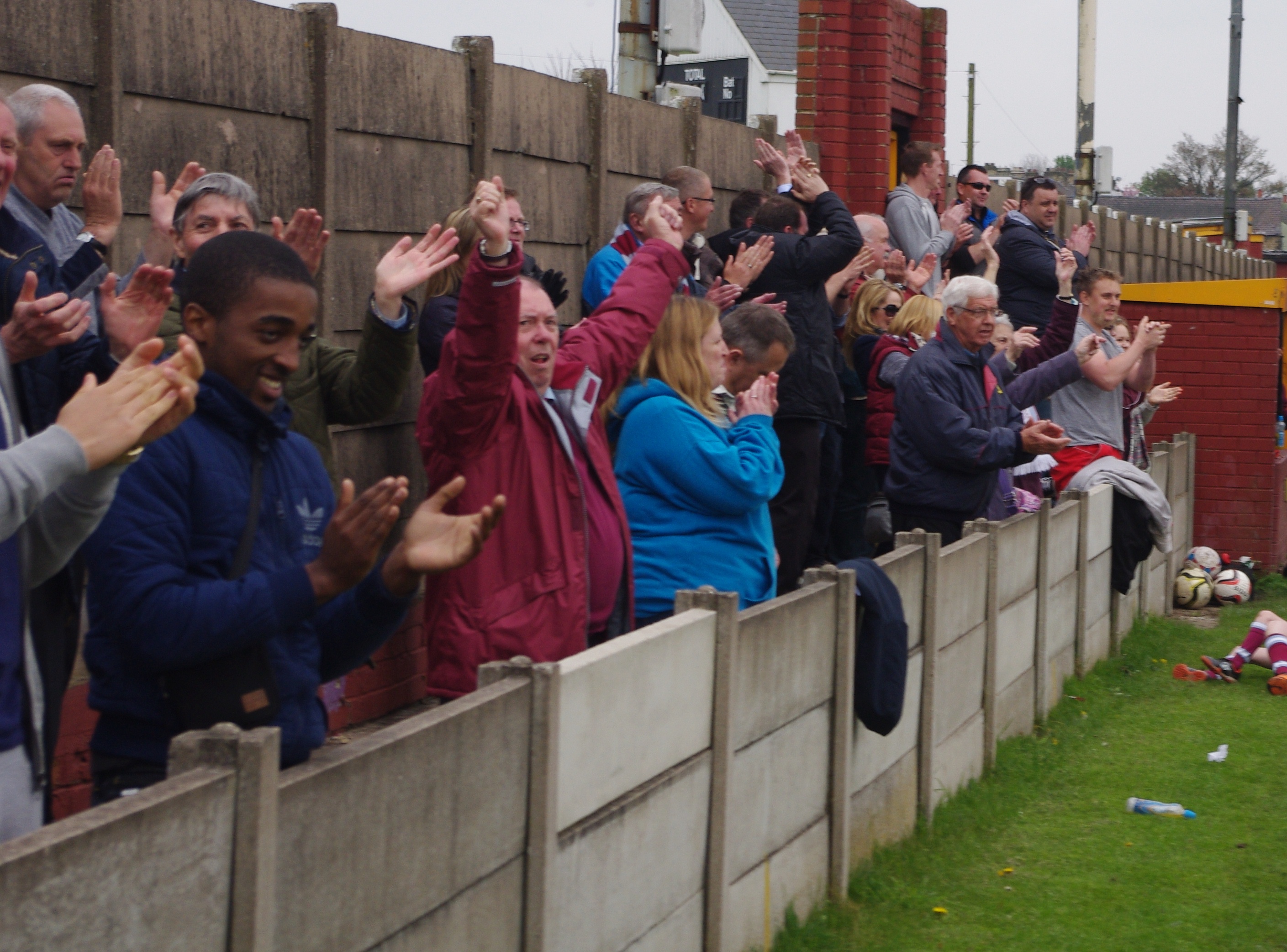 AFC Emley supporters celebrate their team winning the Pat Rice Trophy