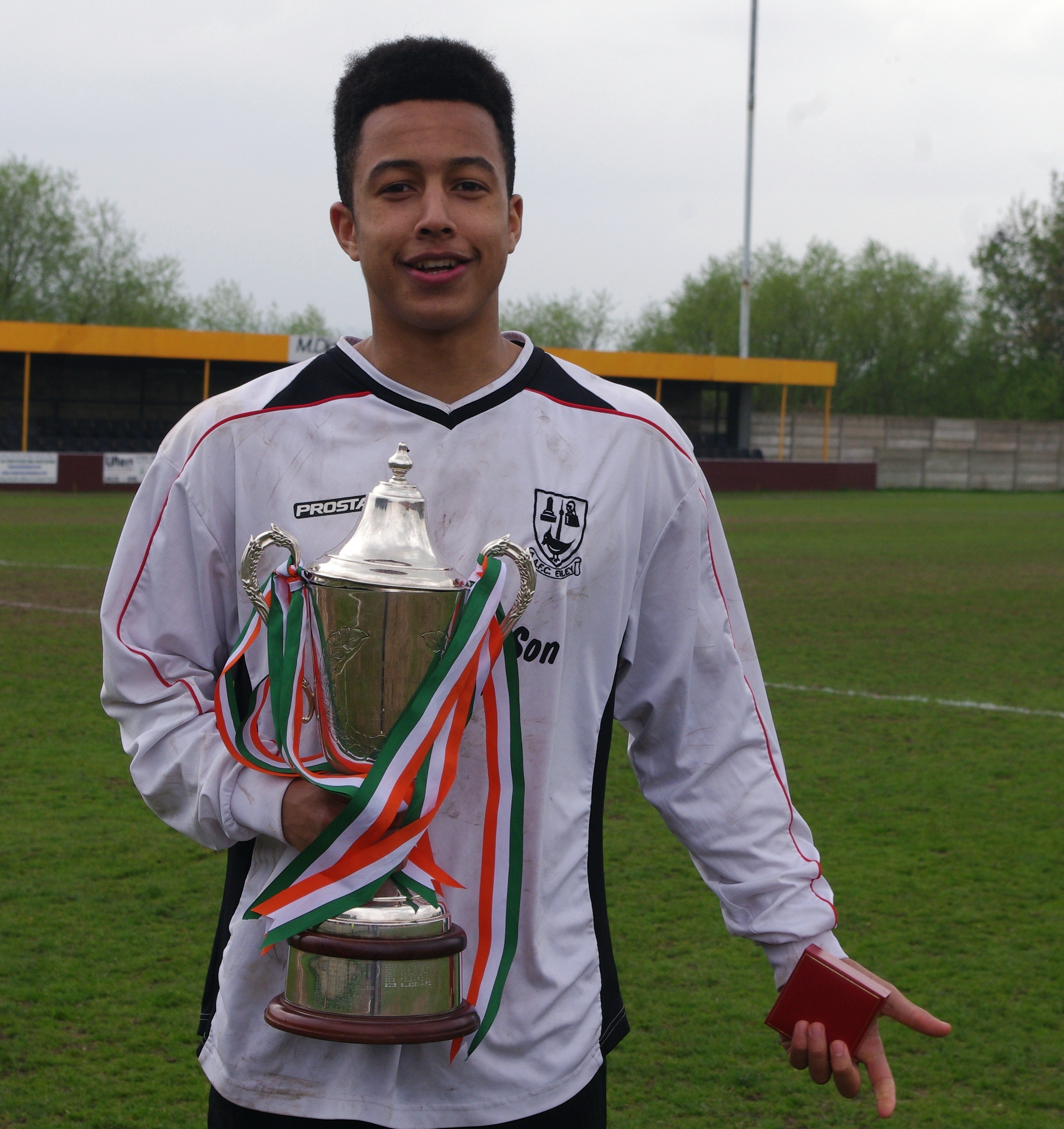 The man of the moment: two goal hero Ruben Jerome with the Pat Rice Trophy