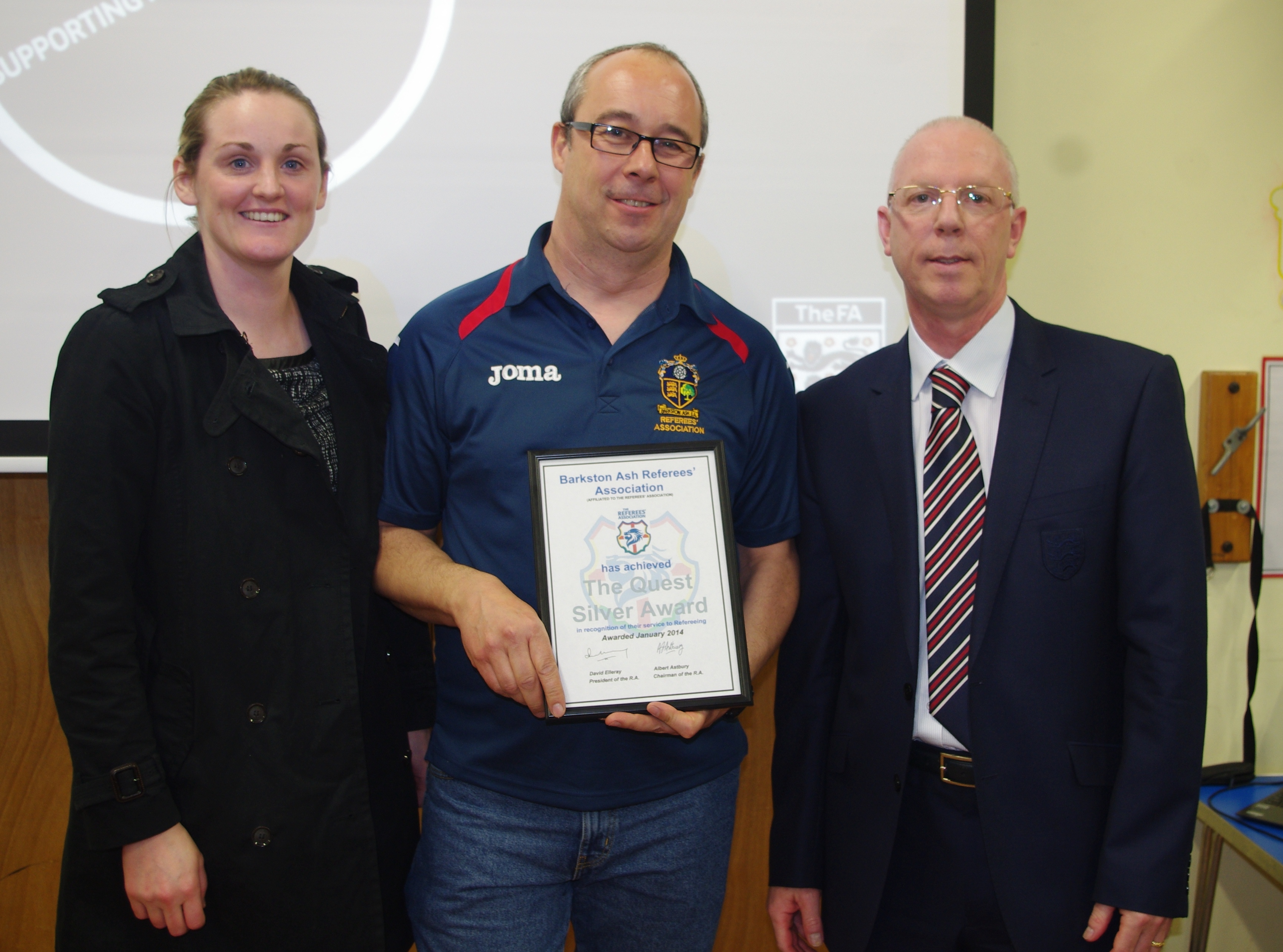 Hannah Simpson was present when Barkston Ash RA chairman Tony Johnson received the Quest Silver award from former Premier League referee Neale Barry (right)
