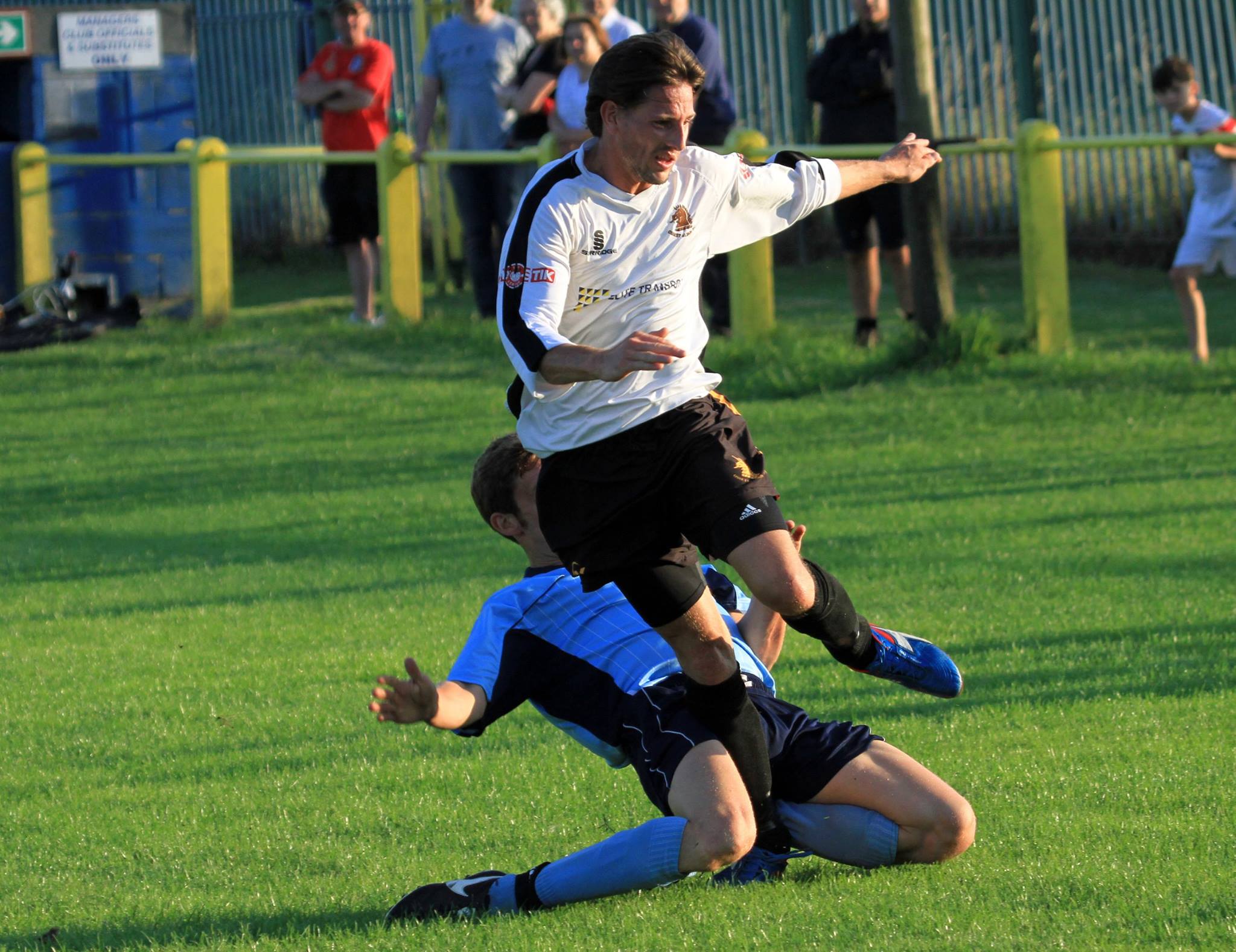 Ossett Albion's Simon Poole is tackled by a Whitkirk defender
