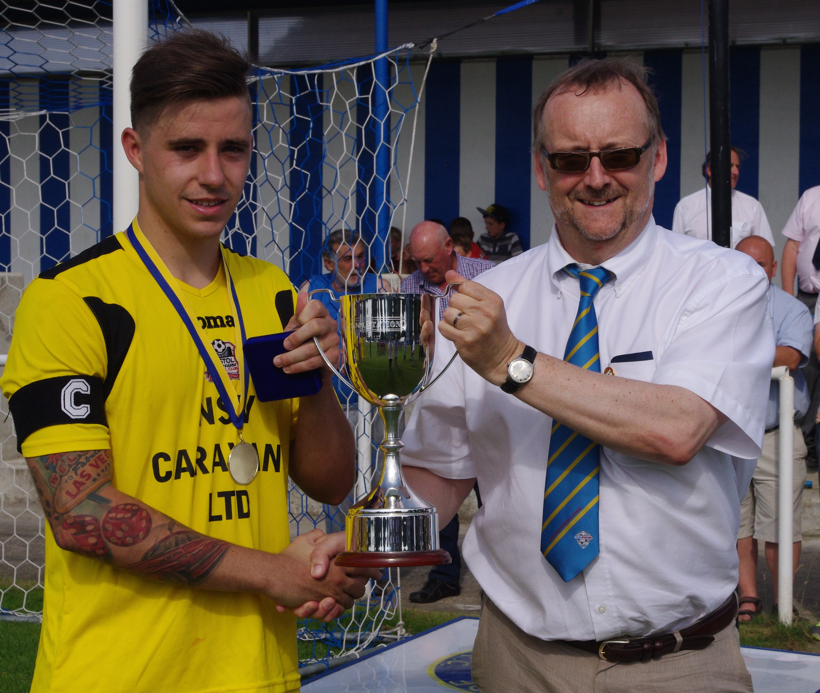 Toolstation commercial director Neil Carroll presents Bristol Manor Farm captain Jordan Metters with the Toolstation Cup