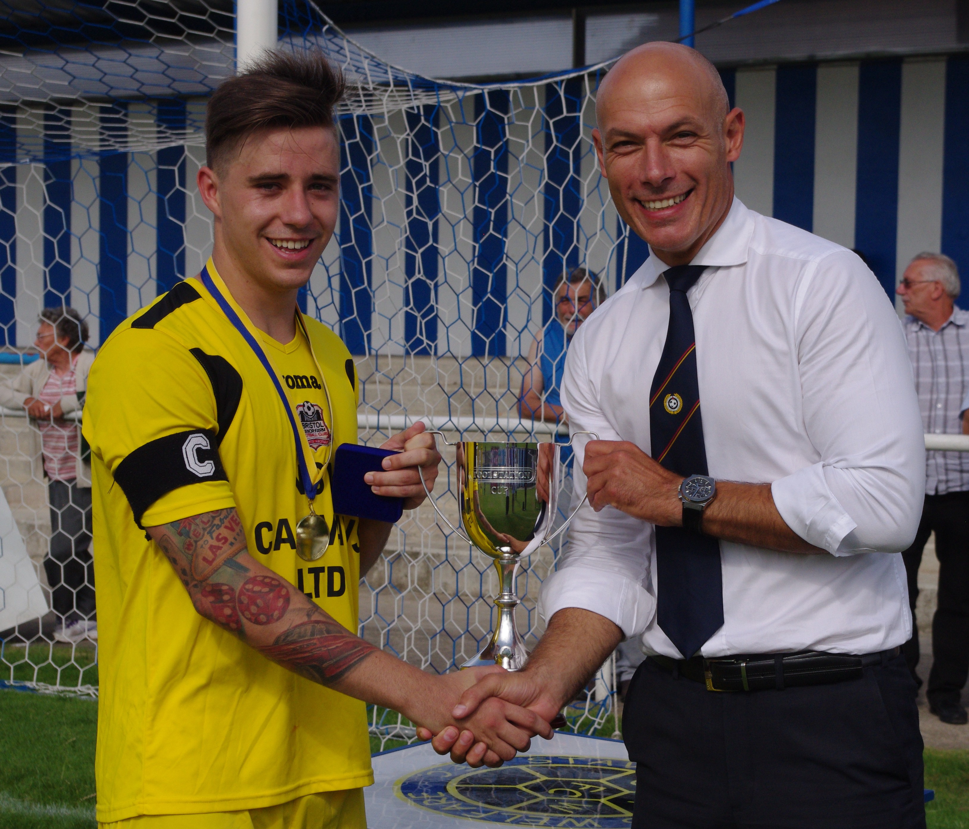England's World Cup referee Howard Webb presents Bristol Manor Farm captain Jordan Metters with the Toolstation Cup after their 1-0 win over Knaresborough Town