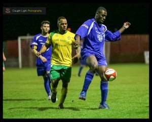 Malachi Farquharson holds off Brighouse's Shaquille Clarke-Adams. Picture: Caught Light Photography