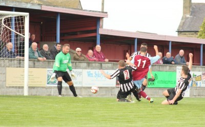 Alex Hallam scores the winner for AFC Emley in their 1-0 win over local rivals Penistone Church. Picture: Mark Parson