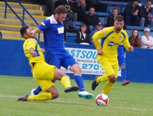 Farsley AFC striker Aiden Savory being tackled during the first half
