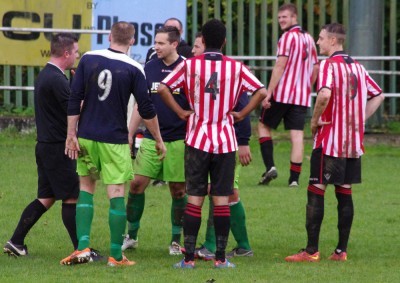 Worsbrough striker Brad Kerr (right) looks on as Nathan Kamara rages at referee Paul Tomes after a comment is made