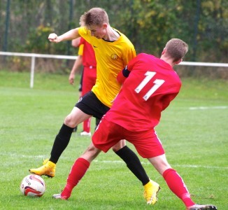 Mark Simpson battles with Parkgate captain Daniel Abdula 