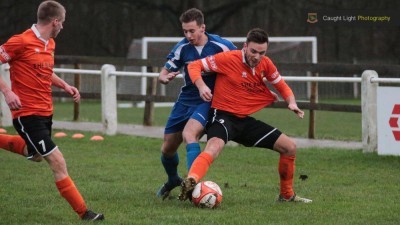 Harrogate Railway winger Adam Baker tries to win the ball off Brighouse's James Hurtley