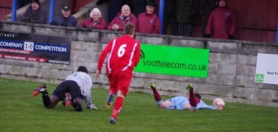 Max Leonard lies on the ground after being fouled by Suwara Bojang