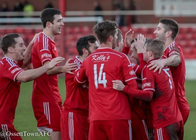 Ossett players celebrate club captain Steven Jeff's only goal of the game against Padiham. Photo: Mark Gledhill