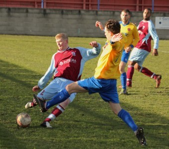 Josh Ingham tries to play the ball forward for AFC Emley. Picture: Mark Parsons