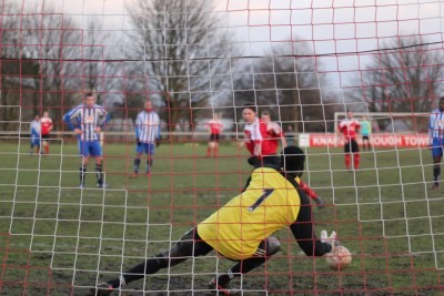 Suwara Bojang dives to save Knaresborough striker Mitch Hamilton's penalty. Photo: Craig Dinsdale
