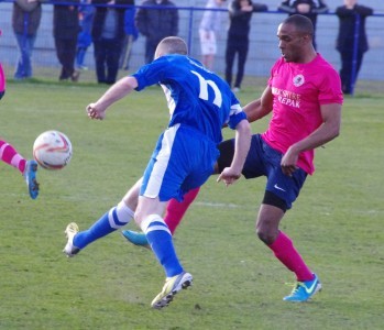 Anton Foster in action for Shaw Lane in the FA Vase defe to Glossop