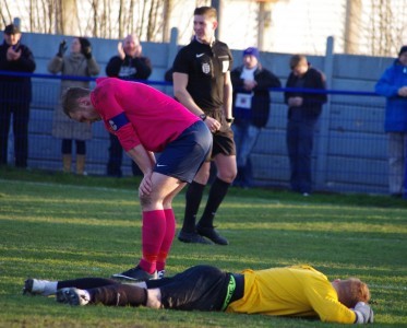 Shaw Lane captain Sam Denton and goalkeeper Ben Gathercole look deflated after Shaw Lane lost the FA Vase quarter-final replay at Glossop