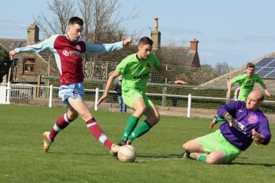 Selby Town manager/stand-in goalkeeper Dave Ricardo stops Max Leonard in his tracks