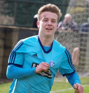 Nick Guest kisses the Hemsworth Miners Welfare's badge after scoring their third in the 3-0 win at AFC Emley