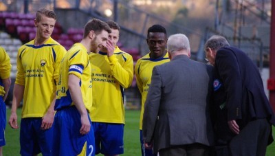 Garforth captain Andy Hawksworth introduces West Riding County FA officials, president Bob Secker and vice-president Eric Beedham to his team-mates and mascots