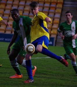 Garforth's highly-rated young defender Jack McCarthy wins the battle with Chib Chilaka