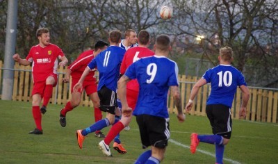 Shaw Lane captain Sam Denton heads for goal in his side's 2-1 win over Albion Sports