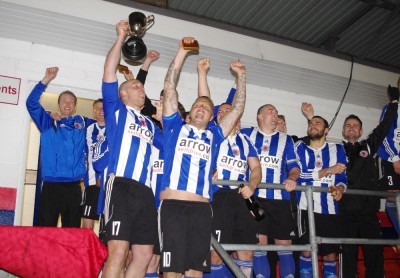 Sam Denton lifts the Toolstation NCEL Premier Division trophy in April for Shaw Lane