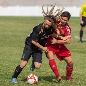 Sam Akeroyd in battle against Ossett Town. Picture: Mark Gledhill