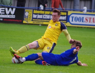Liam Ormsby tackles Harrogate Town's Lloyd Kerry