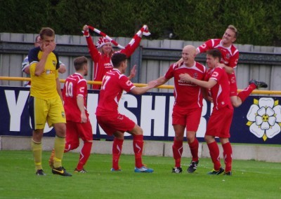 Game over: Colne celebrate one of their late goals