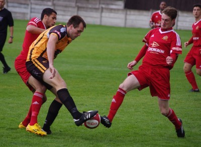 Ossett Albion defender Danny South attempts to clear the ball