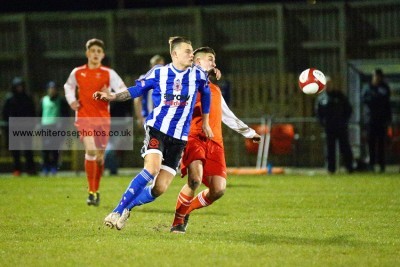 New Shaw Lane midfielder Reece Hands attempts to pull away from Stocksbridge's Spencer Maw. Picture: whiterosephotos.co.uk