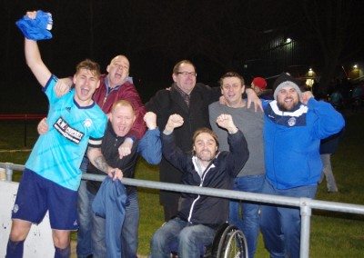 Hemsworth captain Jason Yates celebrates promotion with a handful of the club's volunteers and supporters