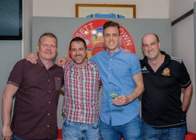 Ossett Town defender Simon Rogers (second right) collects his supporters' player of the year trophy