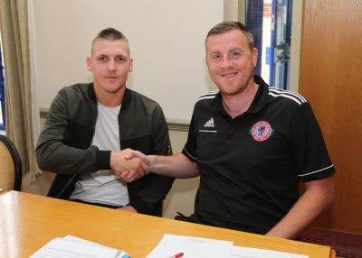 Ozzie's back: Oscar Radford shakes hands on a deal with Shaw Lane AFC manager Craig Elliott. Picture: Gary Frost