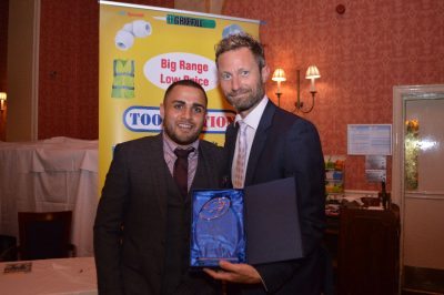 AFC Emley striker Ash Flynn collects his special achievement award from Toolstation representative John Meaden