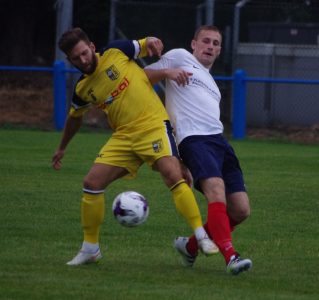 Tadcaster's Jason Mycoe battling with Harrison Blakey