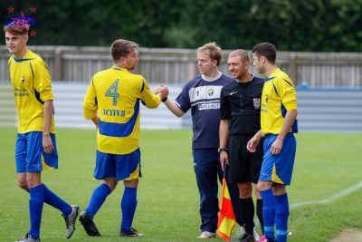 Garforth Town Legends manager James Grayson shakes hands with Andy Sunley as the midfielder comes off