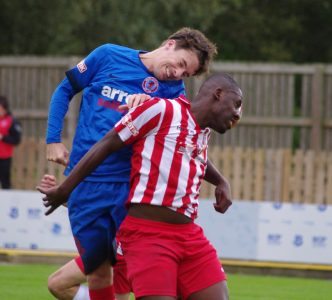 Kelvin Lugsden in an aerial battle with former Harrogate Railway striker Malachi Farquharson
