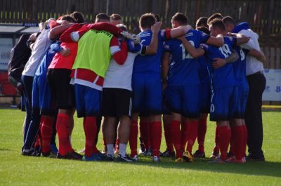Shaw Lane in their huddle at the end of the game