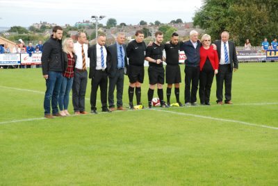 Dan Wilkinson's parents, the match officials and Shaw Lane's officials during the minute's silence 