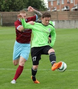 AFC Emley left-back Liam Schofield (in green) in action in the summer. Picture: Mark Parsons